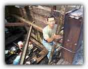 Senior Excavator Gary Takeuchi climbs out of Pit 91
