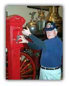 Retired fire-fighter Dennis Murphy demonstrates how citizens would have called for help in the early 1900s