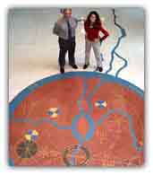 Stephanie and historian Chris Moore wave from the cosmogram that depicts Langston's life