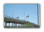 Flags fly high over the free trade zone of the U.S. and Mexico